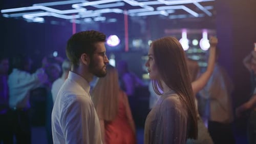 Couple Of Lovers Looking At Each Other In Neon Light Of Night Club. Romantic Date In Rhythm Of Mu...