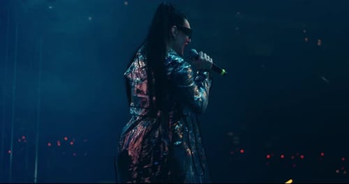 Female Singer Performing Live on Stage at Concert