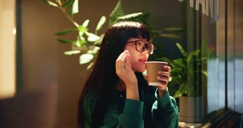 Asian woman, thinking and drinking coffee in cafe for relax, break and window for peace in Japan