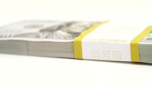 Stack of Bank Bundles with US Dollars on a White Background Closeup Shot of New Freshly Printed