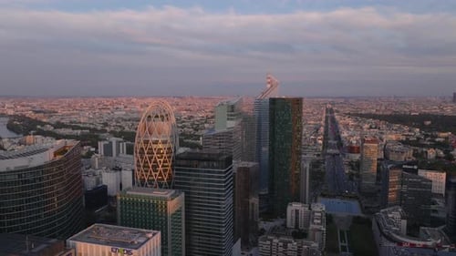 Aerial Ascending Shot of Futuristic Office Skyscrapers in Business District La Defense at Sunset