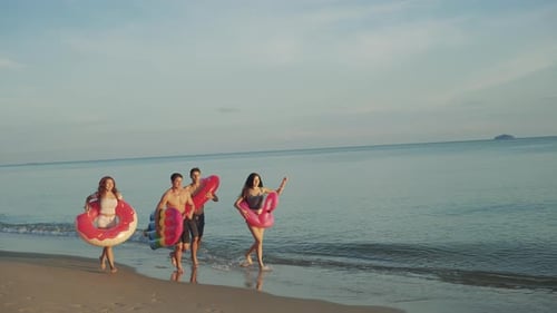 Slow motion: Close up group friends running enjoy life playing and freedom beach at sunset