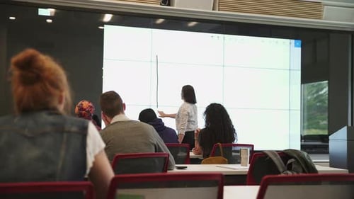 Math Teacher Using Smartboard in Lecture Theatre 4549 Years
