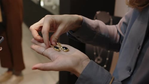 Hands of Two Diverse Women Choosing Gift in Premium Jewellery Store