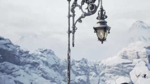 Vintage Street Lamp Illuminated Under Winter Snow in a Mountain Landscape