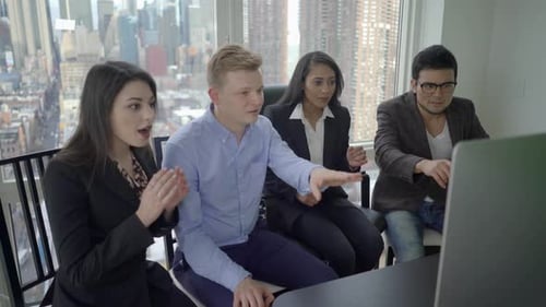 Enthusiastic Team Celebrates Success in Urban Office