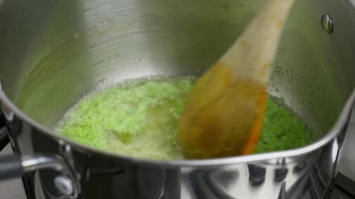 Cooking Video. Close up of food cooking simmering in a pan full of curry sauce, soup or stew placing
