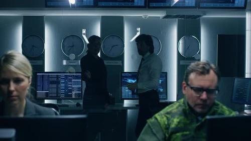 Government Cybersecurity Agency Professionals Working on Personal Computers in Cooperation with Arm