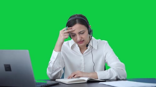 Confused Indian call center girl talking to customer Green screen