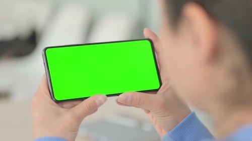 Close Up of Woman Holding Smartphone with Chroma Key Screen