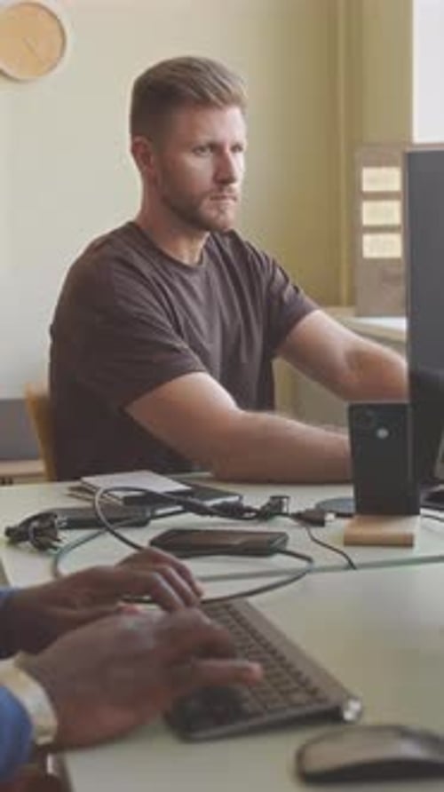 IT Specialists Working on Computers in Office