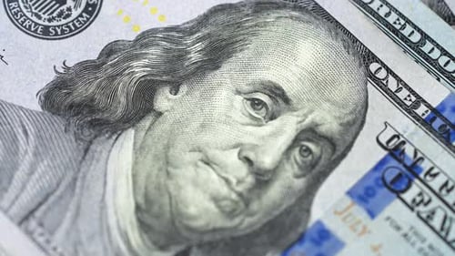 Closeup Examination of US Hundred Dollar Banknotes Showcasing Its Features