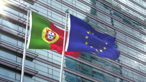 Portugal and European Union Flags Waving Against Modern Office Building
