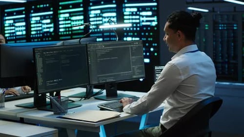 Developer Working in Data Center on Computers