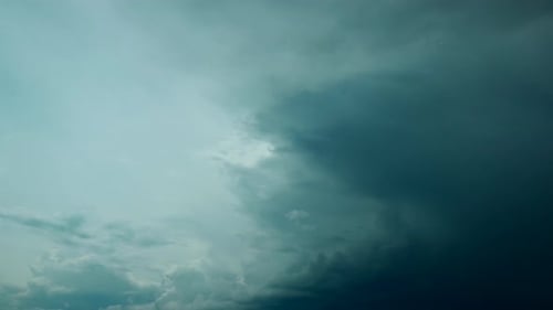Dark Sky Clouds Rolling Slowly Across the Horizon