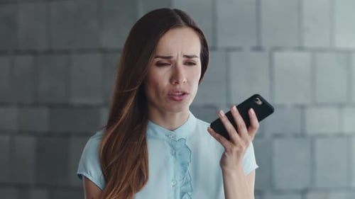 Closeup Sad Businesswoman Talking on Phone Loudspeaker at City Street. Upset Female