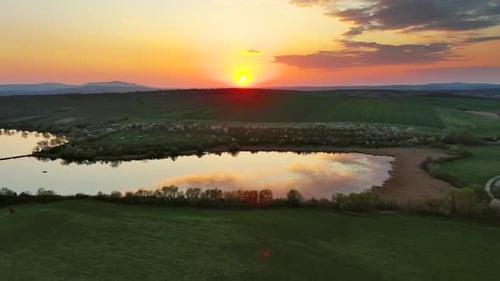 Sunset Wavy Hills with Fields and Pond