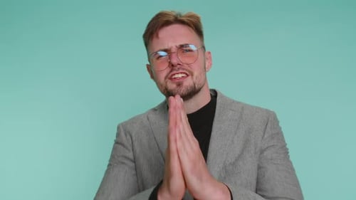 Man Pleading with Hands Together in Studio