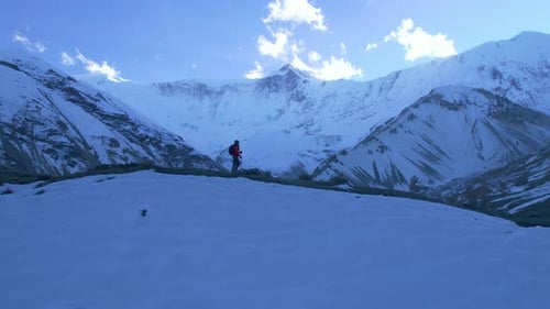 Aerial Circular Close Up View Caucasian Male Hiker on Trekking Trail Way with Poles Walk to Tilicho