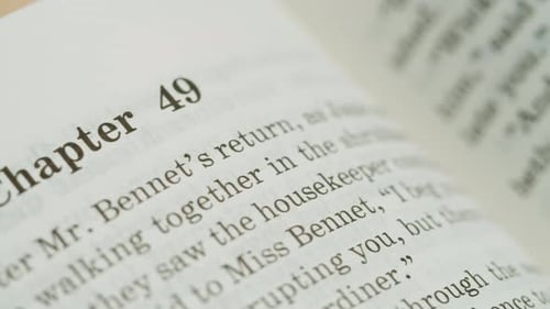 Woman Hands Flipping Spanish Language Book Pages Reading and Education Flicking Through Old Textbook
