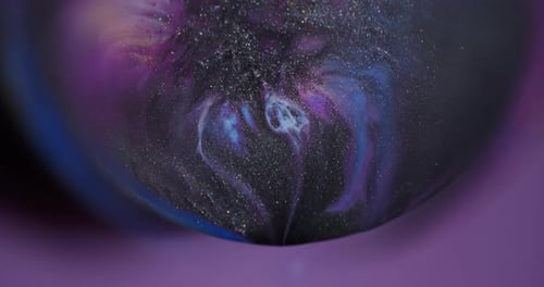 Glittering Swirls of Ink Creating Galaxy Patterns