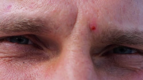 Close Up to Upset Male Face Looking Into Camera with a Disappointing Sight Upset Facial Expression