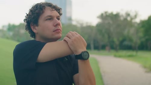Man Doing Warmup Exercises in Park