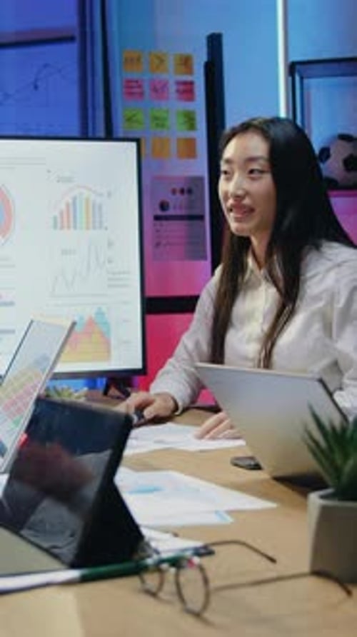 Businesswoman Explaining Data with Handshake in Office
