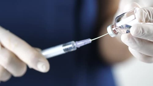 Researcher hand gloves holding flu, measles,coronavirus,covid-19 vaccine disease preparing for human