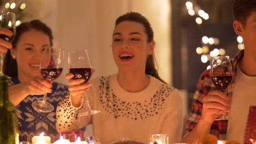 Friends Toasting with Wine at Festive Holiday Dinner