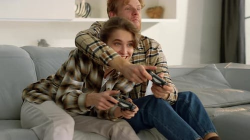Loving Couple Plays Video Games at Home Together