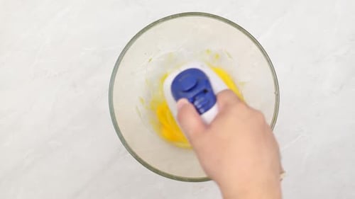 Mixing eggs with corn flour in flat lay look.