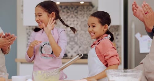 Girls Celebrating Baking Success With Family in Kitchen