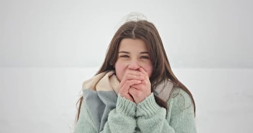 Girl Warming Cold Hands in Winter