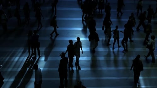Silhouetted People Walking at Night in City