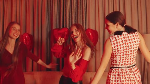 Cheerful Young Women Dancing at Indoor Birthday Party