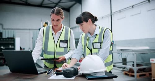 Engineering, laptop and manufacturing with women in workshop for industrial