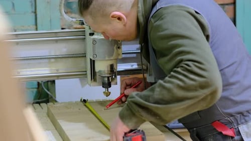 Close Up Carpenter Holding a Measure Tape on the Work Bench Woodwork and Furniture Making Concept