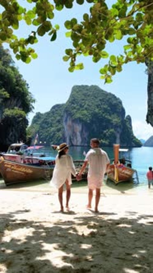A Romantic Couple Enjoys a Leisurely Stroll on the Beach Holding Hands Koh Hong Krabi Thailand