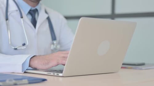 Close Up of Doctor Working on Laptop