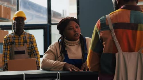 Warehouse Employees Discussing Distribution at Front Desk