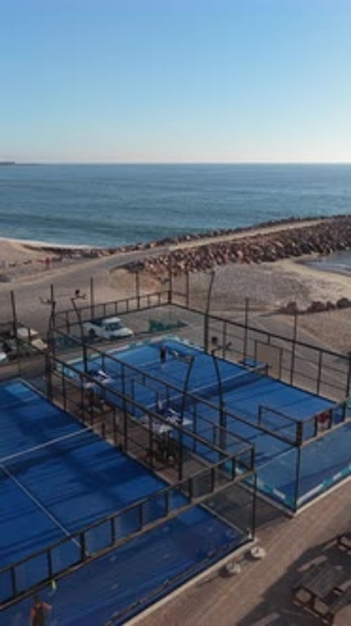Vertical Aerial Shot Circling Above People Playing Padel Tennis at Coastal Resort in Swakopmund