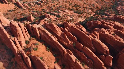 Thin ridges of red rocks in the dry desert. Canyons of the Arches National Park
