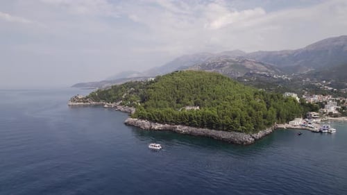 Aerial of boat sailing the Albanian Riviera in Himare Ionian Sea Coast