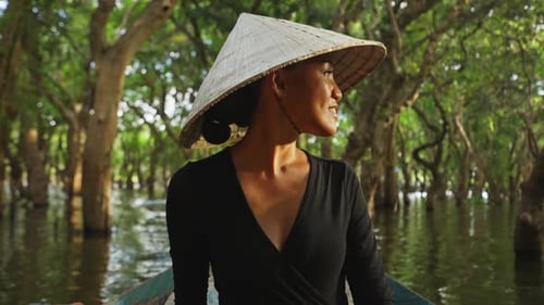 A Woman Riding A Boat In The Mangroves