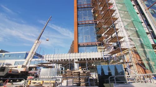 Máquinas y suministros cerca del edificio en el sitio de construcción