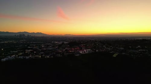 Aerial View Across Los Angeles with Evening Orange Sunset Skies, USA.
