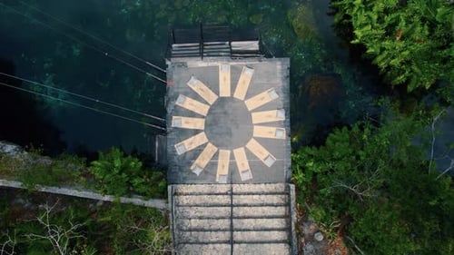 Aerial view of an area for meditation and yoga in a beautiful cenote with transparent blue turquoise