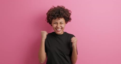 Yes I Did It. Overjoyed Afro American Woman Clenches Fists Feels Lucky
