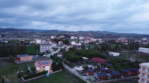 Aerial above suburban area with mountain landscape view in Albania.